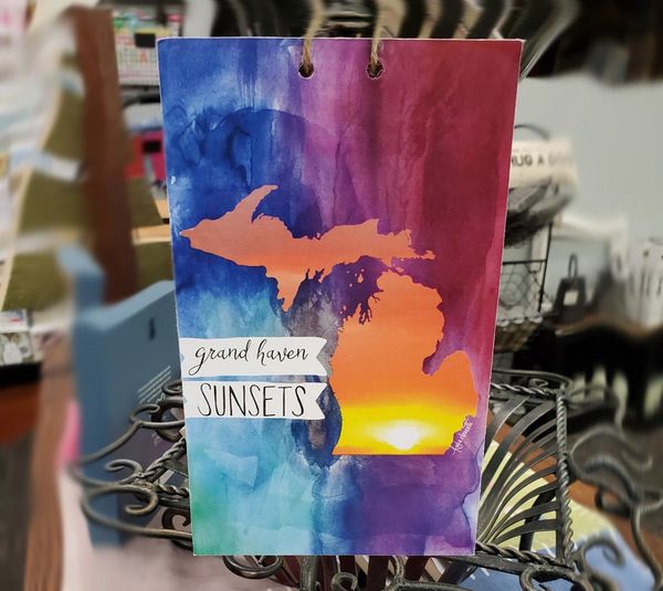 Image: colorful painting of Grand Haven Sunsets on map of Michigan