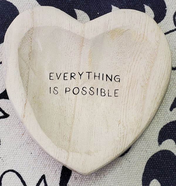 Image; carved wooden heart with the engraved words everything is impossible 