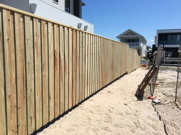 Overlapped and capped pine paling