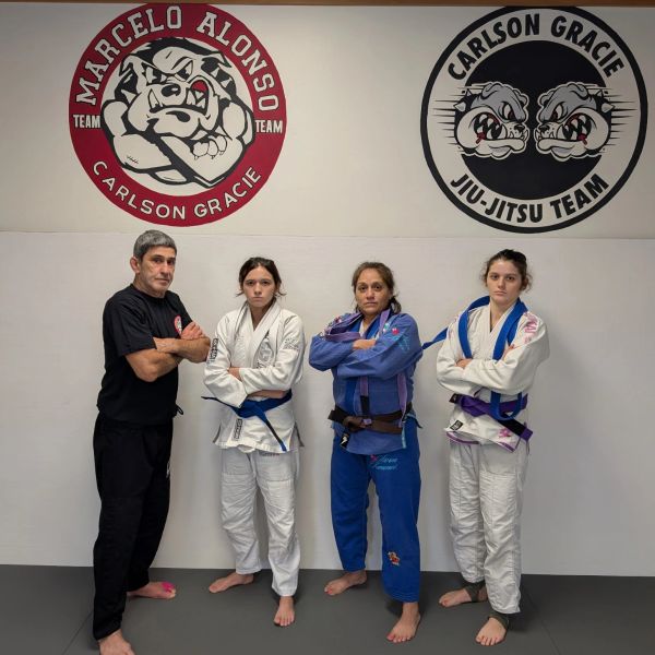 Four martial artists posing in front of Marcelo Alonso and Carlson Gracie logos.