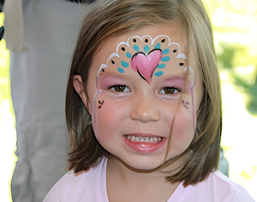 Smiling girl with colorful face paint