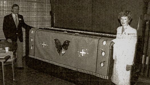 Black and white picture of a couple posing in front of a parament