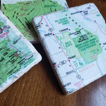 A set of stone coasters featuring a national park map from an atlas