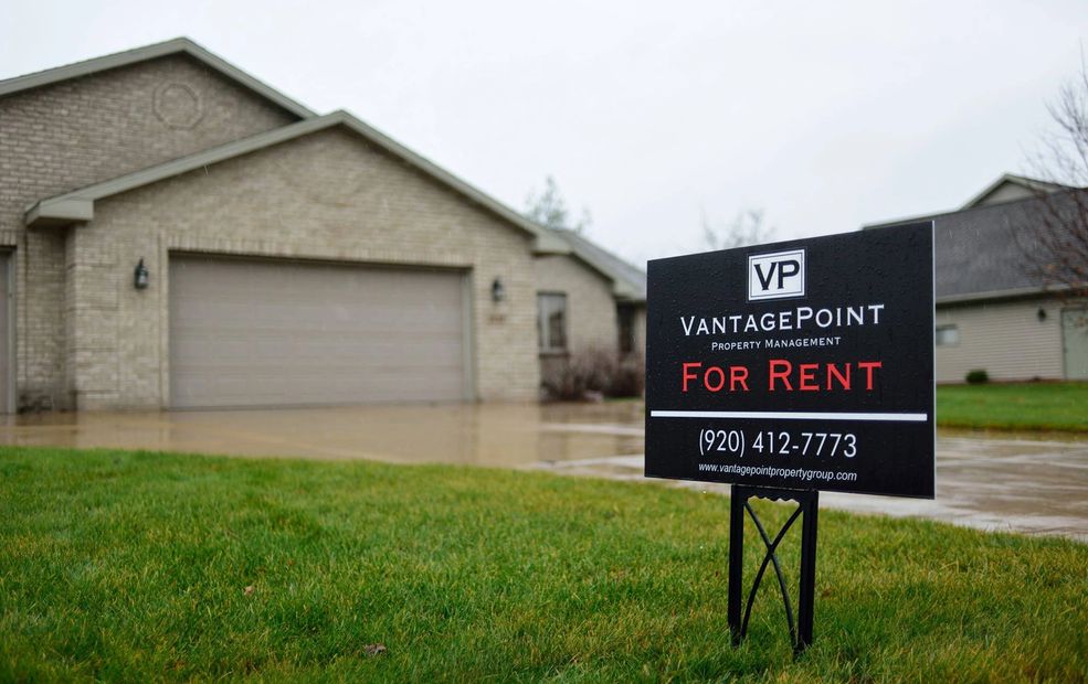 For Rent Sign in a Yard containing contact information for VantagePoint Property Management