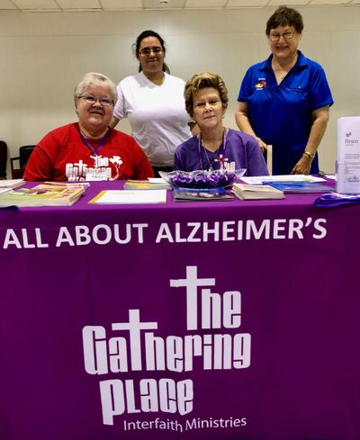 Volunteers at an information booth share with the public about Alzheimer's and the services offered.