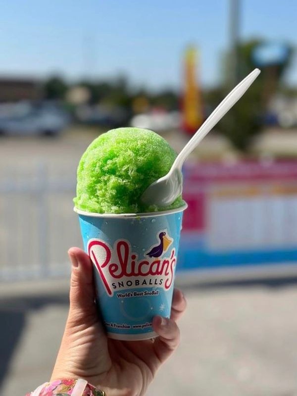 Hand holding green Pelican's Snoball