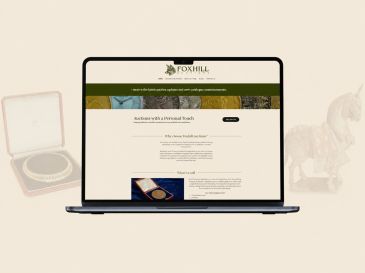 Laptop showing Foxhill Auctions website homepage.