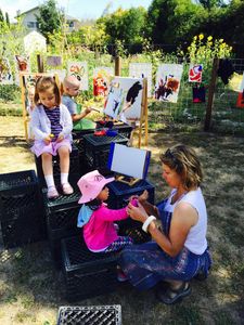 Preschool school child and preschool teacher painting outside