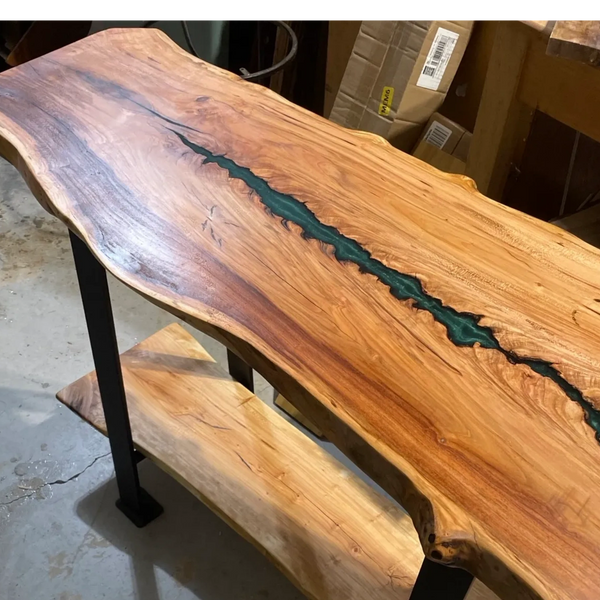 Cherry live edge console table custom built with two levels and green epoxy in the natural split.