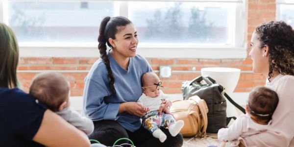 Mothers bonding and playing with their babies indoors.