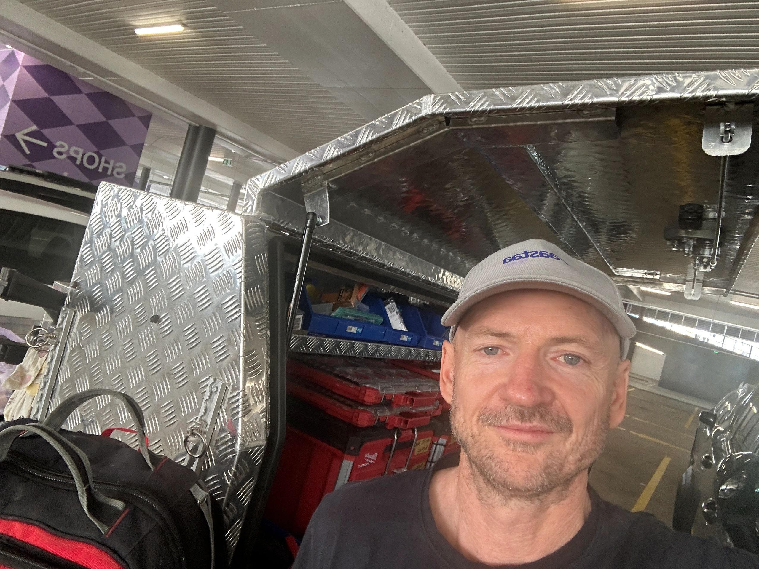 Stack of books next to pencils in a holder and a camera.