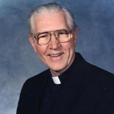 Father Walter Parish wearing round glasses