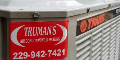 Truman's Air Conditioning and heating service stick on a Trane condensing unit.