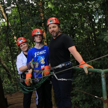 Jennifer with her husband and son on an adventure course