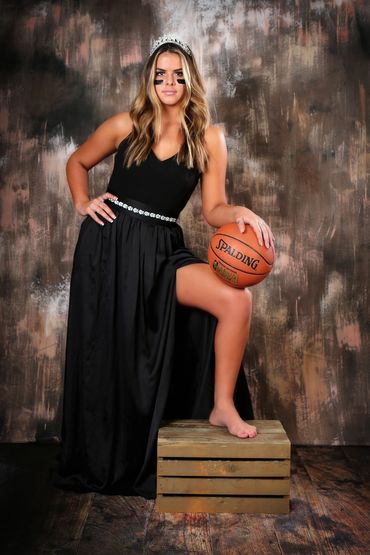Sassy High School Senior portrait of a barefoot girl in long black dress and tiara with basketball