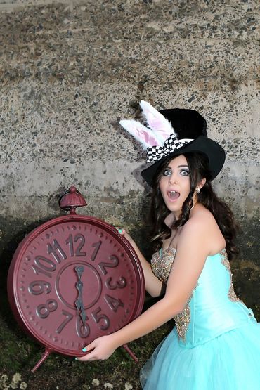 Teen girl in Alice in wonderland themed photo at the beach