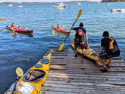 Launching sea kayaks from a ramp, Stonington Maine.