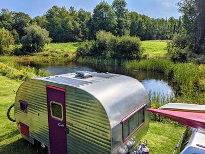Vintage camper parked at a Harvest Host location in Maine.