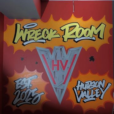 Colorful graffiti on a wall reading 'Wreck Room' with 'Est. 2015' and 'Hudson Valley'.