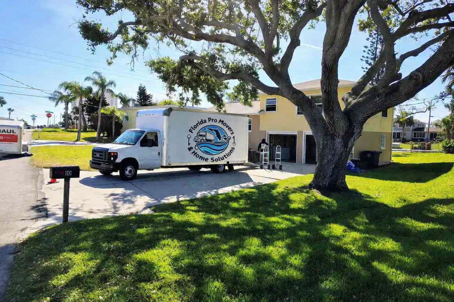 Company truck under a nice tree in port orange, moving a client to there new home .