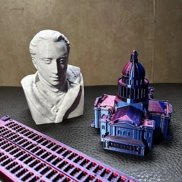 Three 3D printed objects: bust of Charles Barbier, the Pantheon in Paris and an 8 dot braille slate.