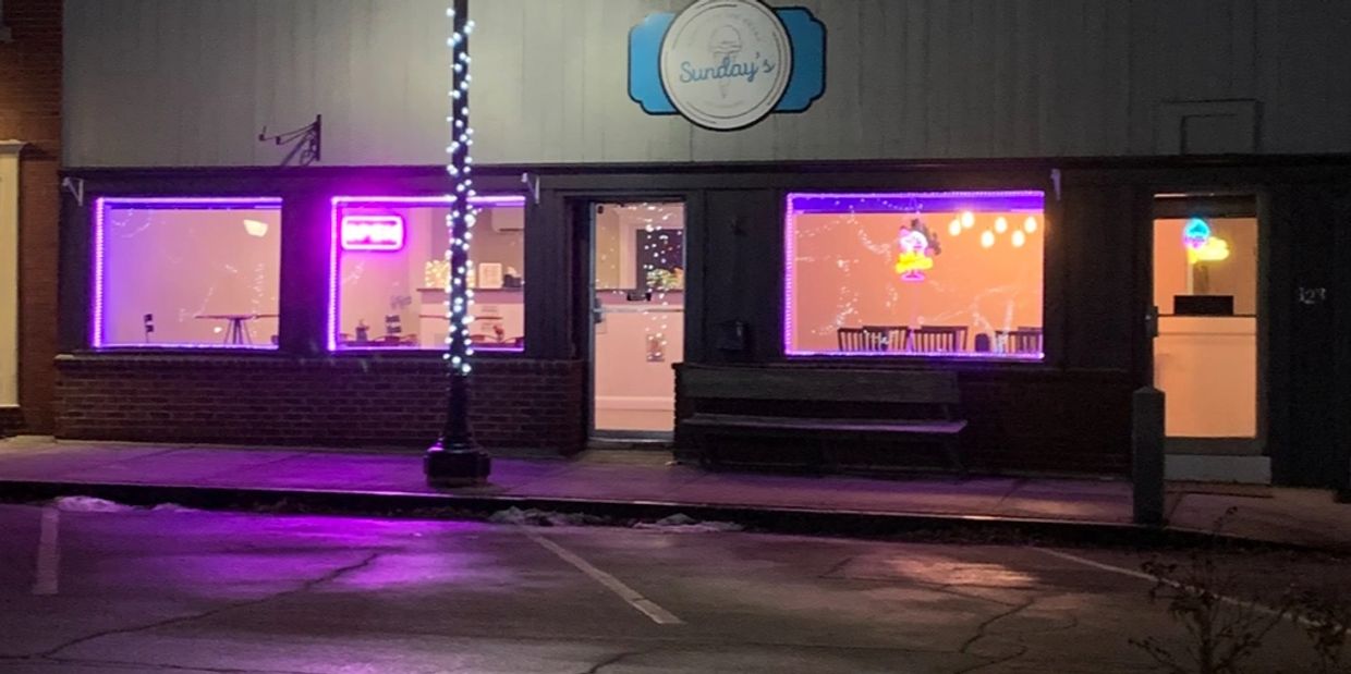 Night view of Sunday’s ice cream shop with purple lights.