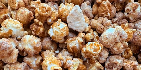 Close-up of seasoned popcorn with spices.