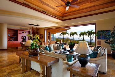 Luxury living room with tropical outdoor view.