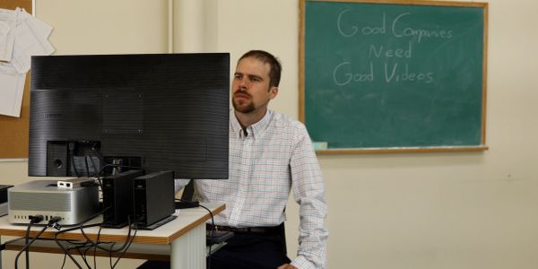 Man working at a computer in an office.