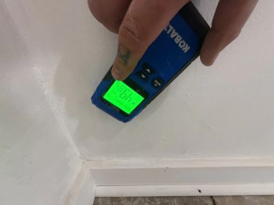 A moisture detector being used during a home inspection.