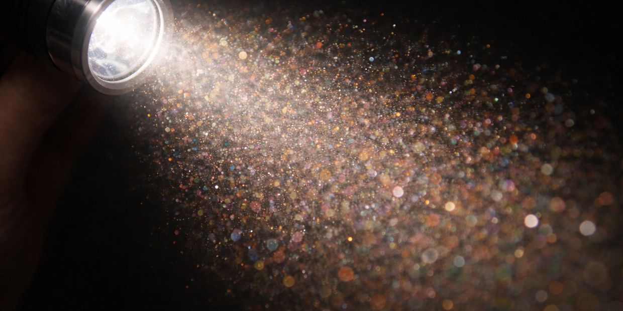 Airborne dust and particles revealed by a flashlight beam indoors