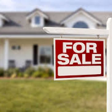 For sale sign in front of a house.