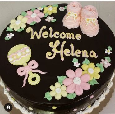 A baby girl welcoming cake decorated with flowers