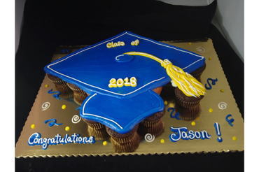A blue colored graduation cake to congratulate Jason
