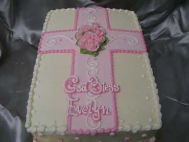 A cross themed cake in pink color 