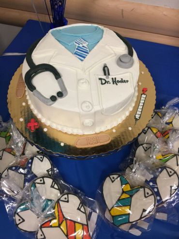 A white coat themed cake with stethoscope 