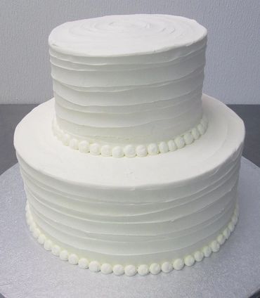 A white colored two tier cake for wedding