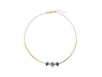 Delicate gold necklace with three blue and white ceramic beads.
