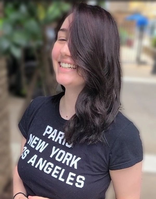 pretty woman leaving the salon with medium brown hair and layers against Peachtree city background