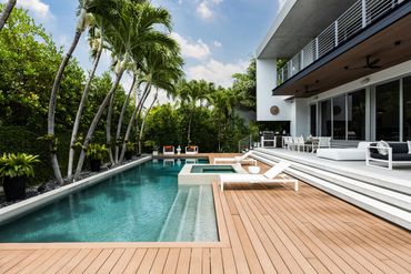 luxury pool, spa, perimeter overflow, glass tile, wood deck, palm trees, Florida modern tropical
