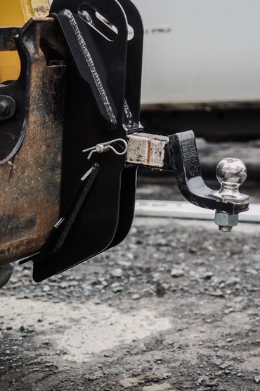 Close-up of a trailer hitch attached to a vehicle's rear.