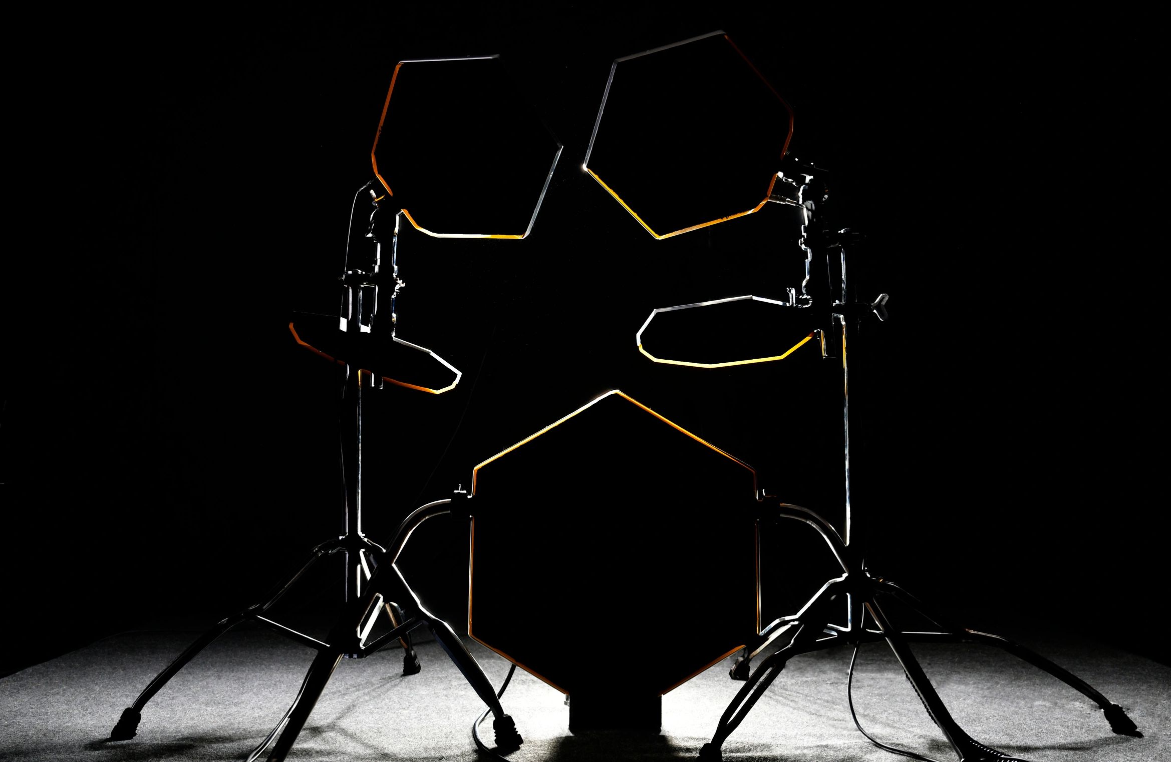 Electronic Drums with hexagonal drum heads - reminiscent of Simmons SDSV Pads - on a dark background