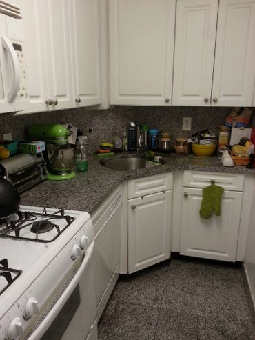 Cozy kitchen corner with white cabinets and granite countertops.