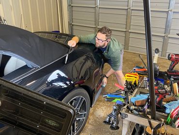 Paintless dent repair on a Mustang rear quarter panel