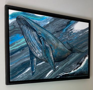 Framed painting of a blue whale swimming in swirling ocean currents.