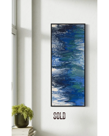 Abstract blue and green fluid art painting in a black frame on a white wall.