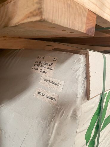 labeled and dated pallets of roof shingles