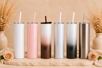 Set of six stylish tumblers with straws arranged in a row.