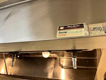 Certification sticker on a commercial kitchen exhaust system