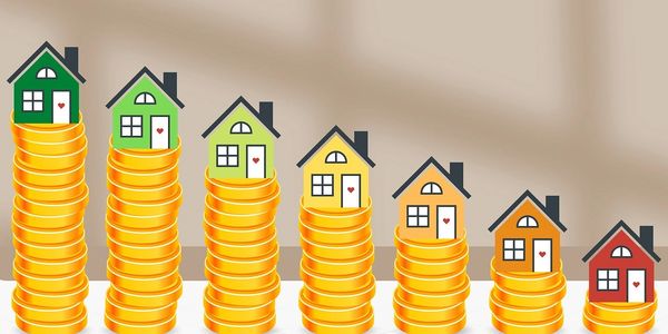 Houses on stacks of coins decreasing in height.